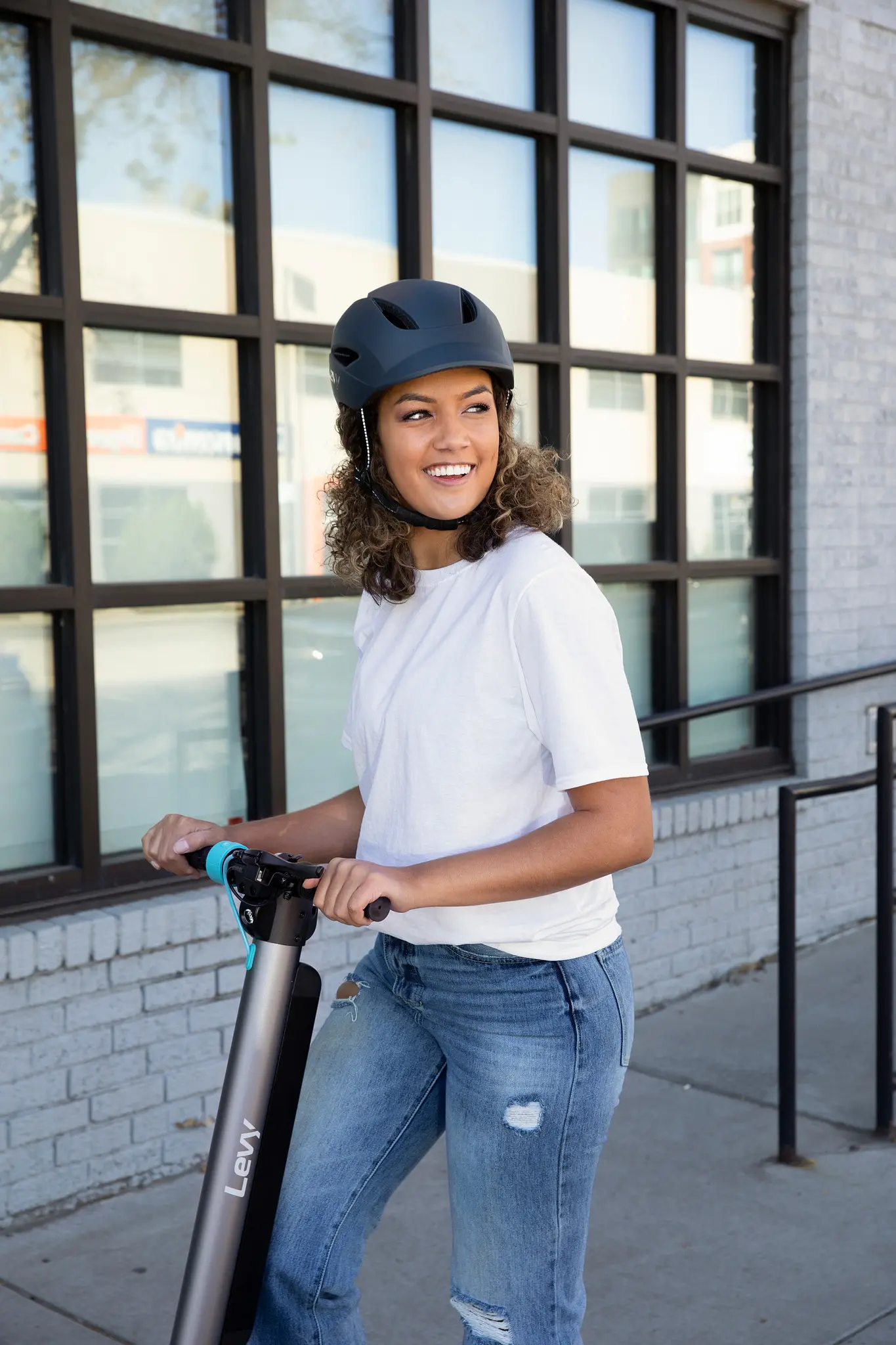 woman on scooter wearing helmet
