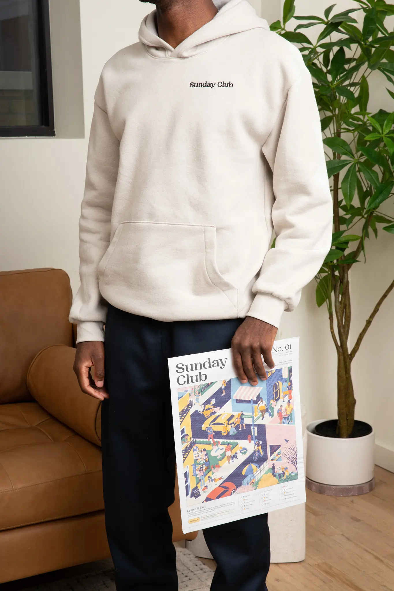 man holding newspaper in living room