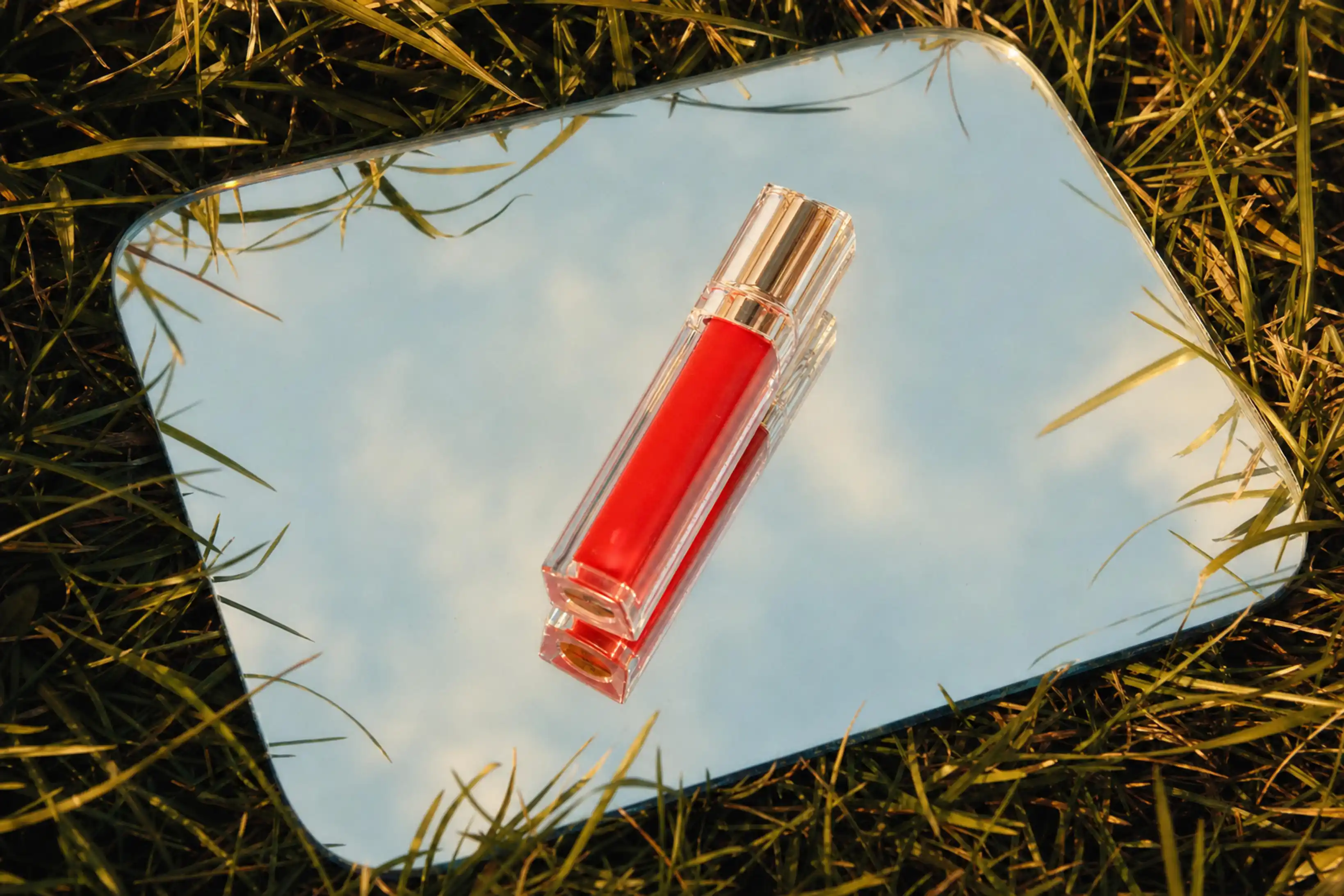 Lavender tube of Zena Skin Vitamin C Cleansing Scrub floating in clear water with light reflections.
