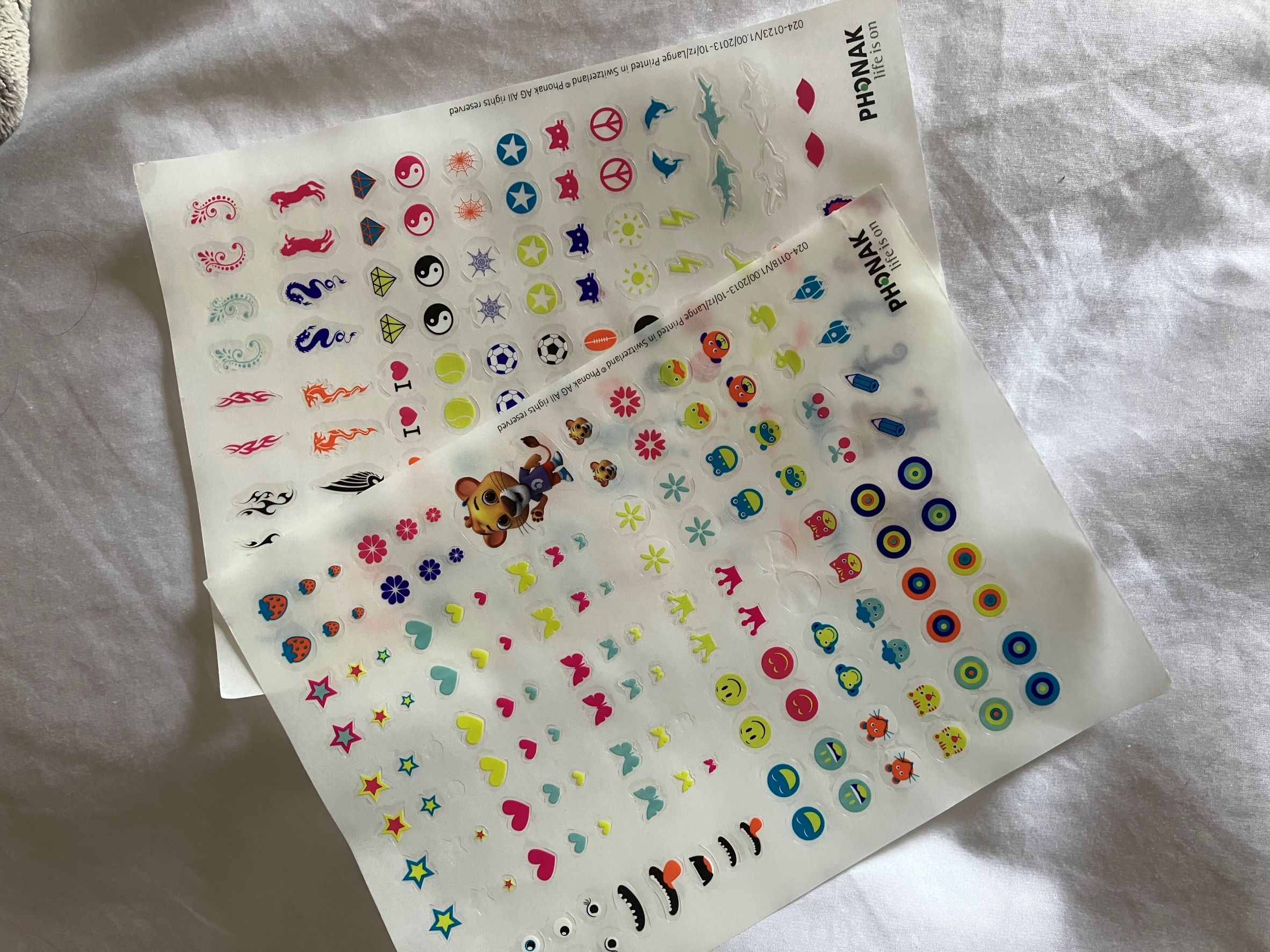 Sheet of stickers for pediatric hearing aids