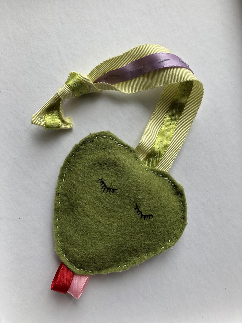 Handmade felt toy snake with ribbon tail for practicing the "ss" Ling sound in speech therapy for hard of hearing babies