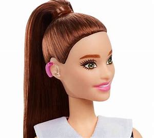Barbie Fashionistas doll #187 with brunette ponytail wearing pink behind-the-ear hearing aids