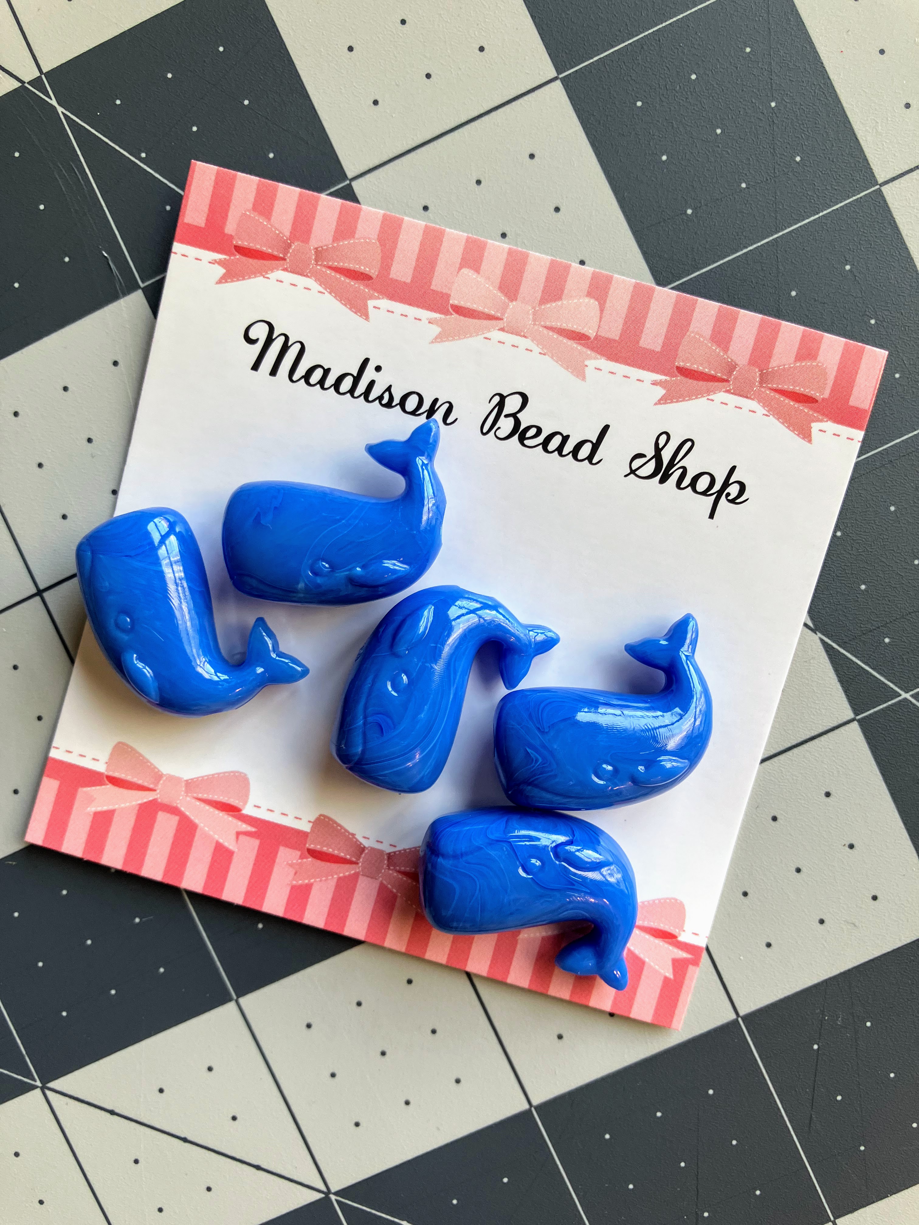 Blue whale-shaped beads for DIY hearing aid doll project on stretchy headband for hard of hearing children