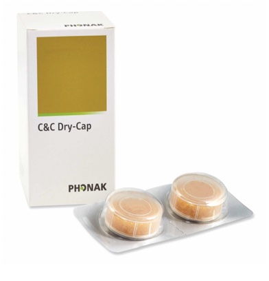 Container of moisture-absorbing capsules next to box of same