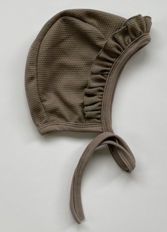 Taupe mesh hearing aid bonnet with ruffle trim and ties, baby pilot cap