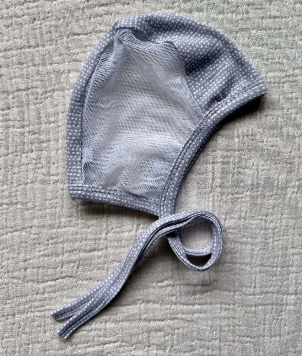 Emmifaye hearing aid bonnet with gray polka dot print and mesh lining, includes ties