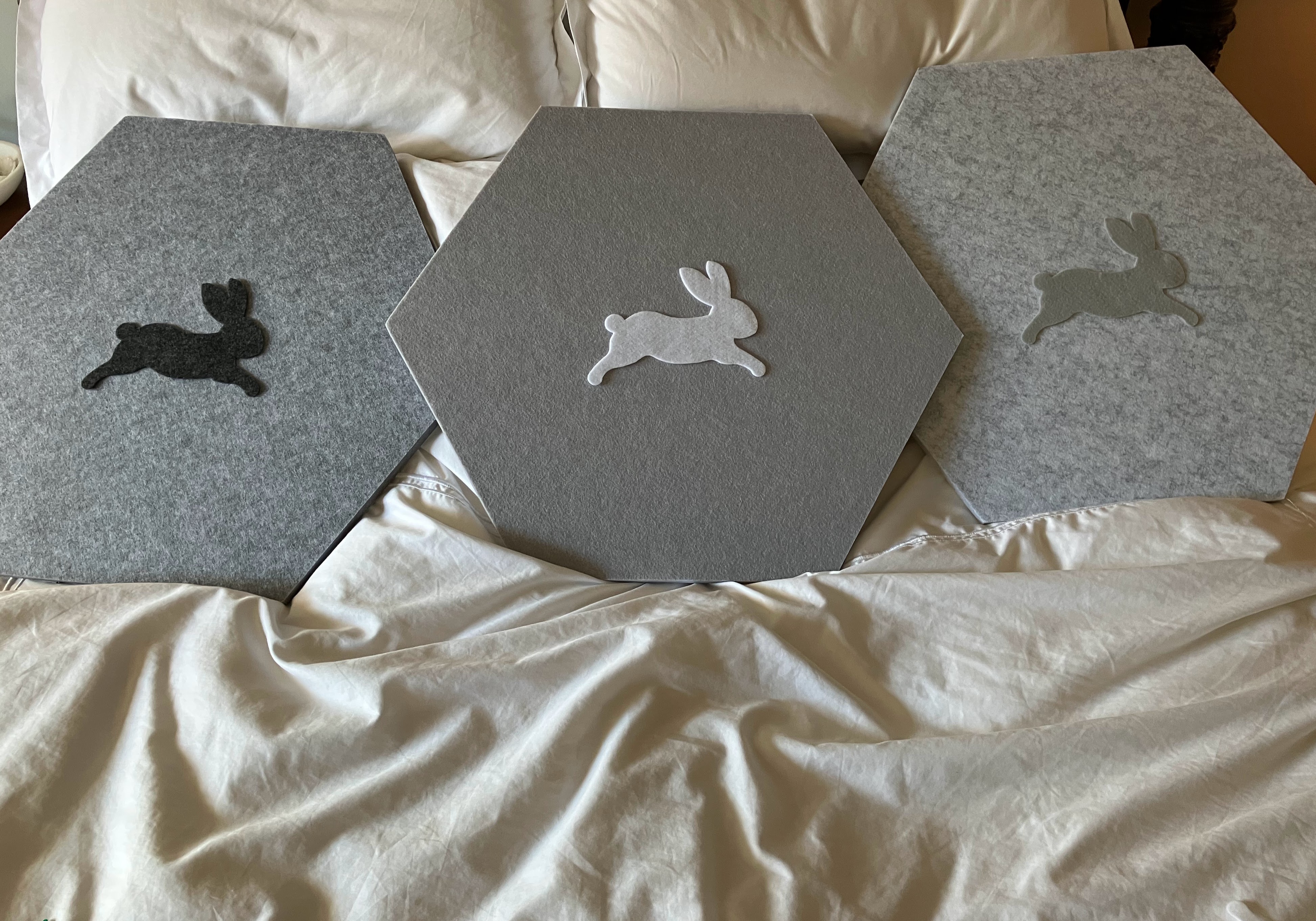 Gray hexagonal acoustic panels with felt rabbit designs for sound dampening in toddler room with hearing loss