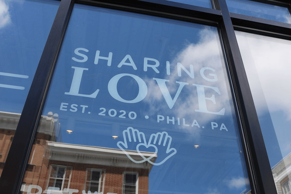 Storefront window lettering for Sharing Love in Philadelphia