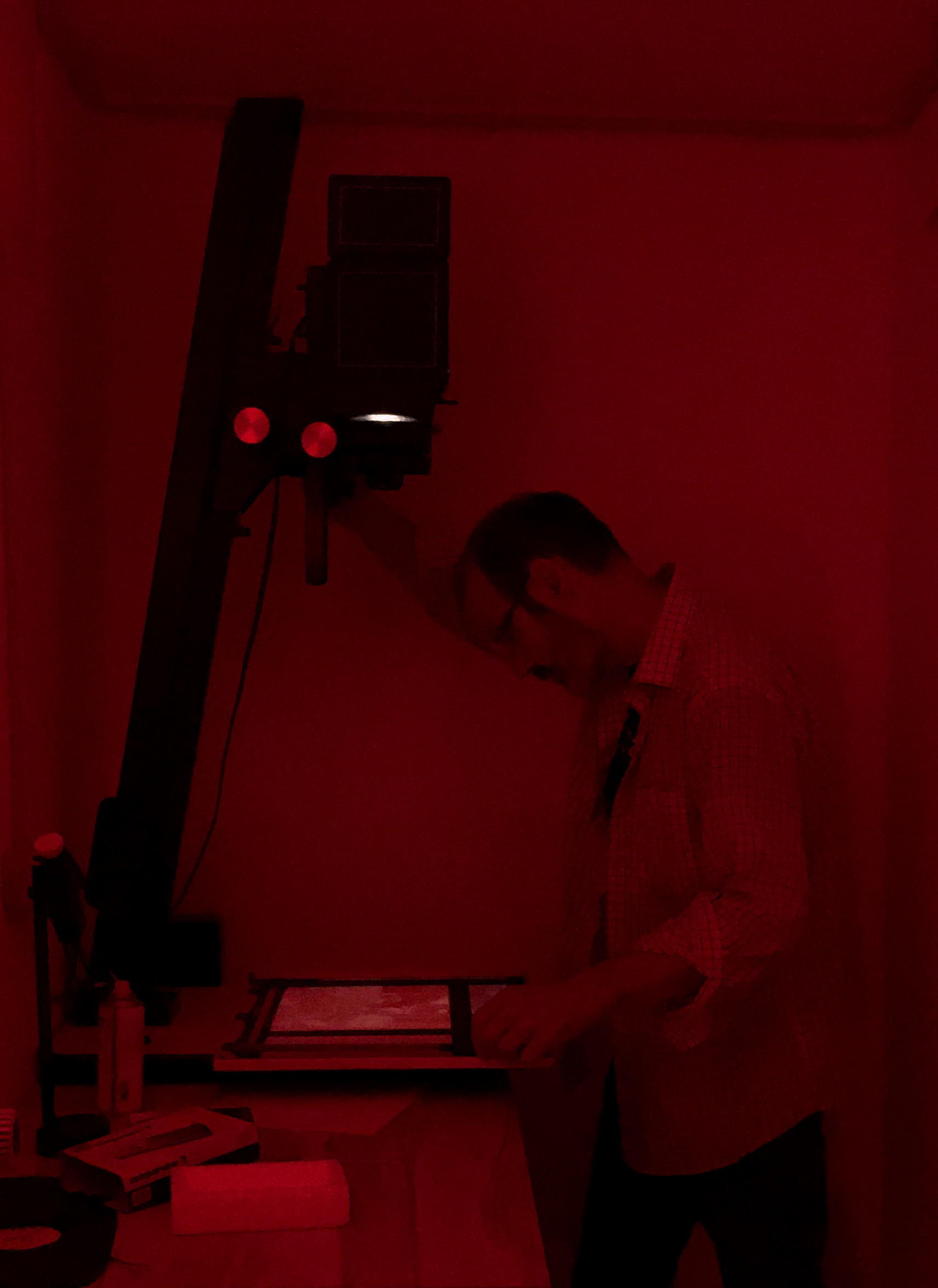 Enlarger in the darkroom under red light 