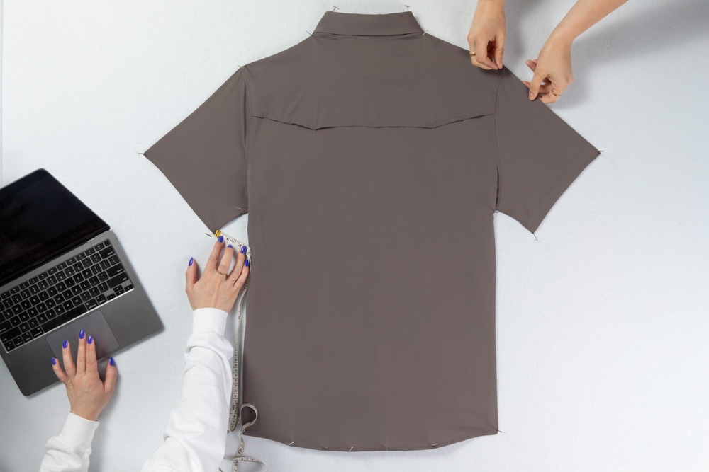 Stylists pinning shirt to pinboard