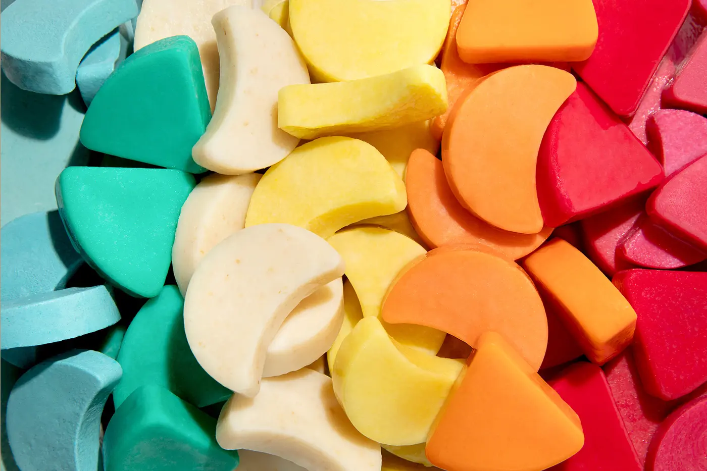 Pile of solid Ethique soap and shampoo bars in rainbow formation
