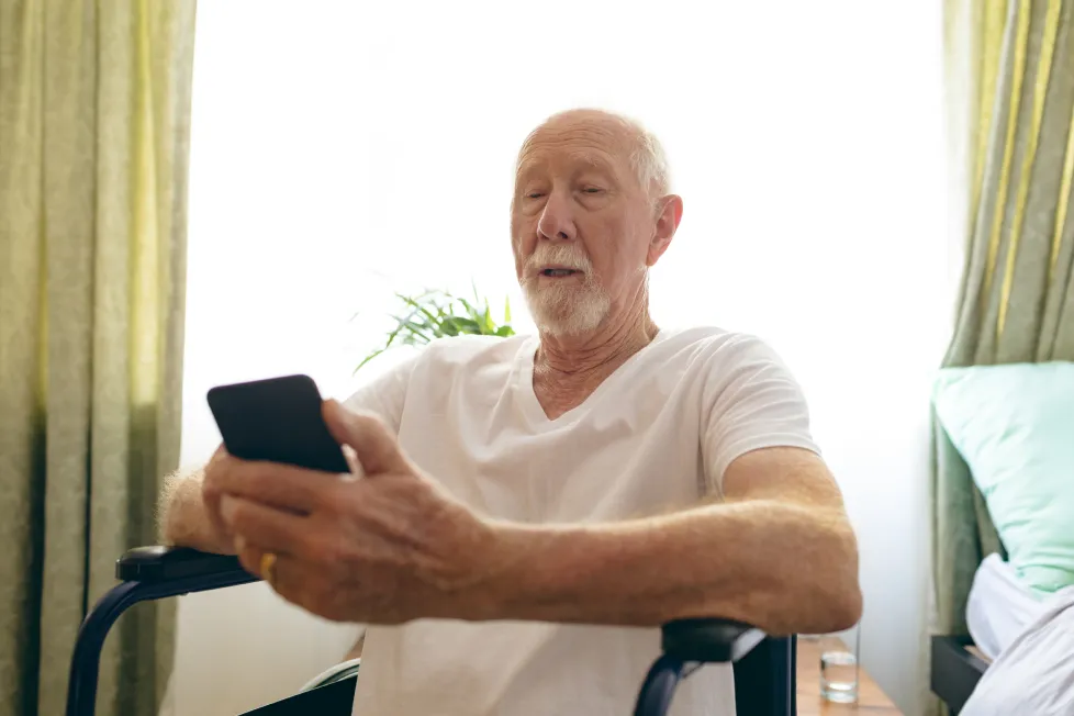 old man looking at phone