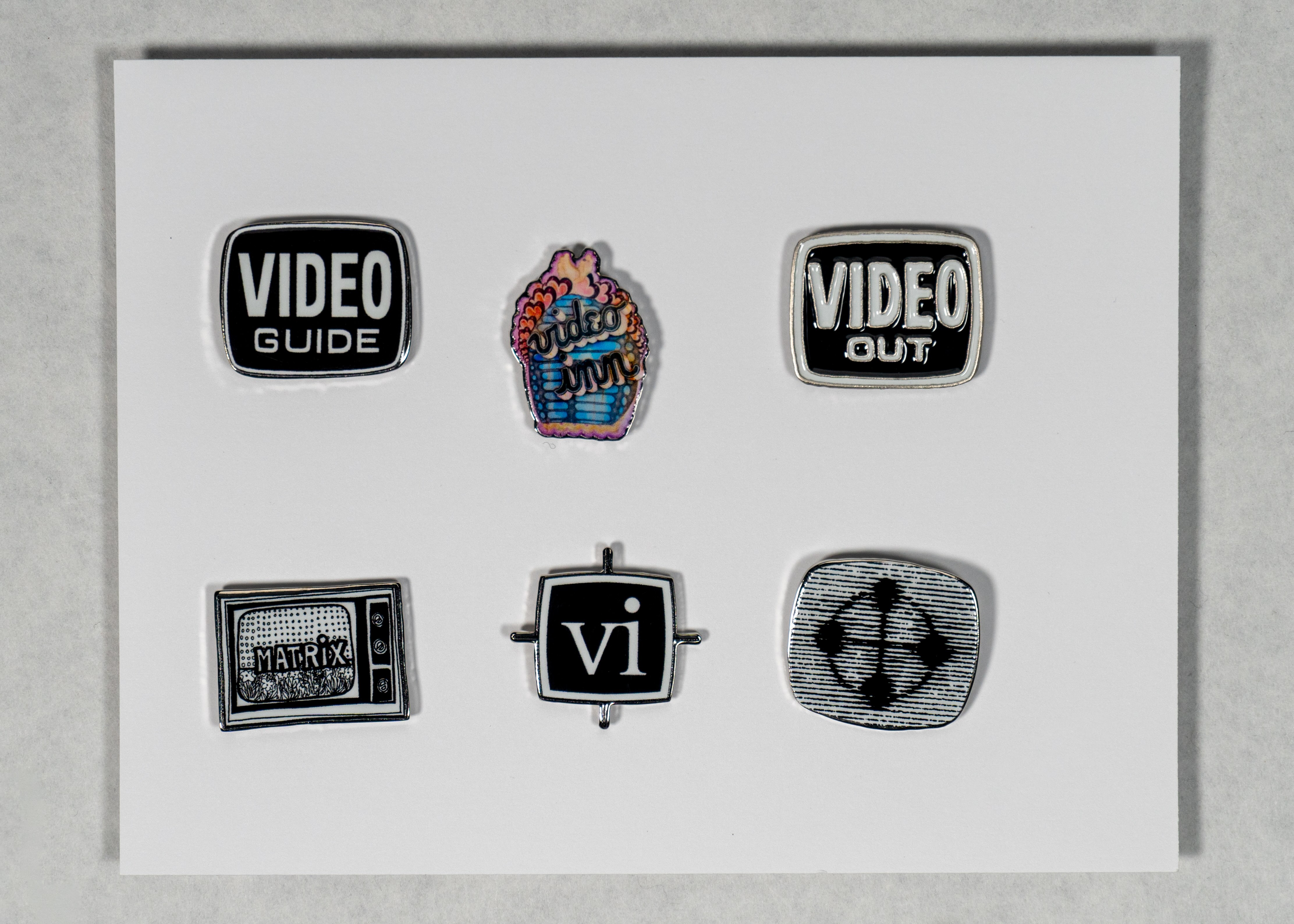 Six pins on a white background.