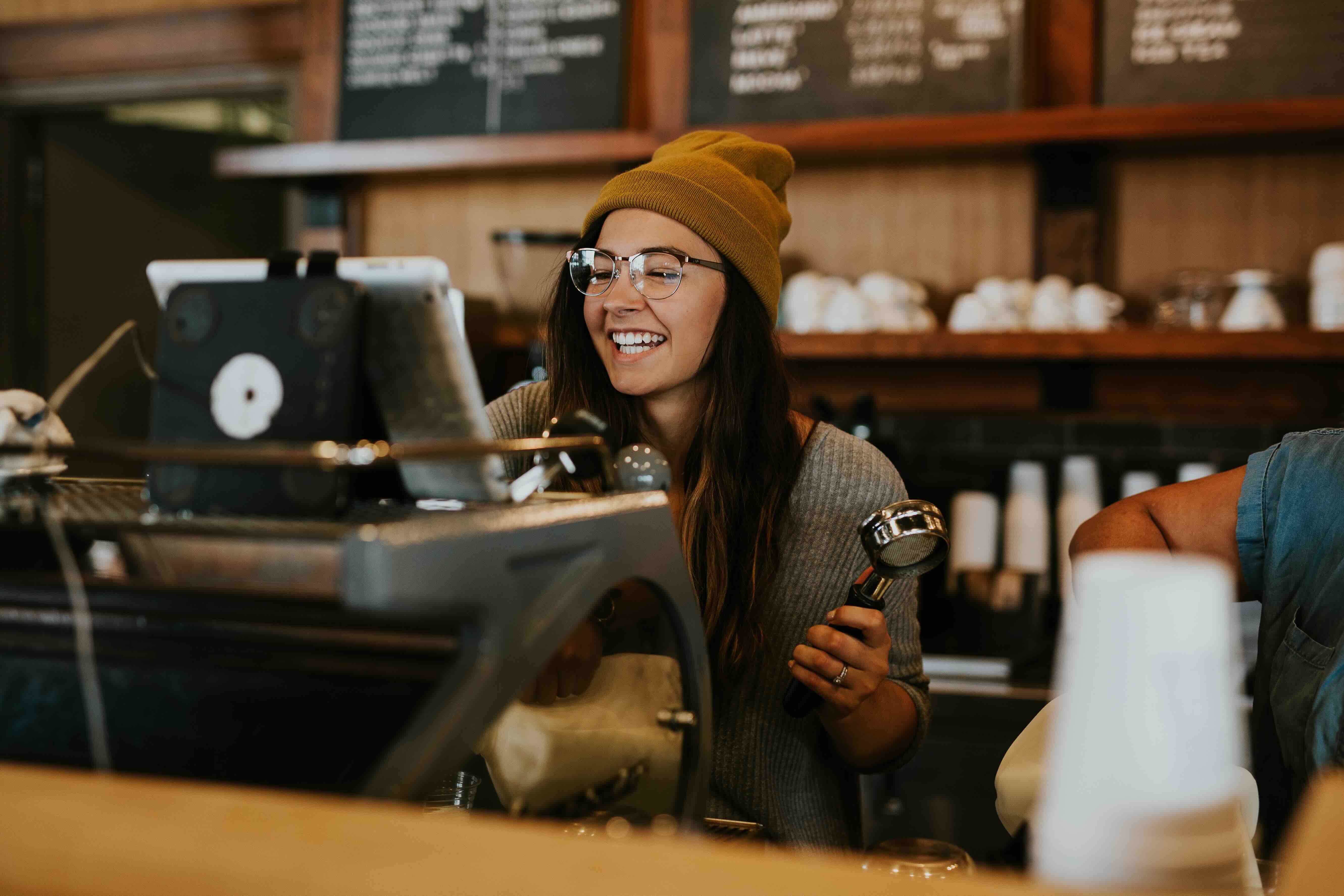 girl making a coffee using machine in cafe