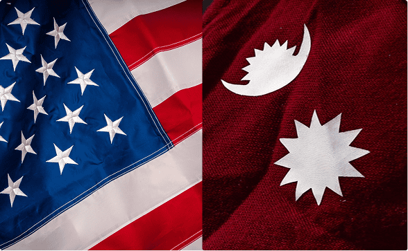 Close-up of the American flag on the left and the Nepalese flag symbols on red fabric on the right.