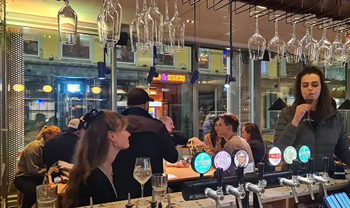 A group of people hanging out in a bar