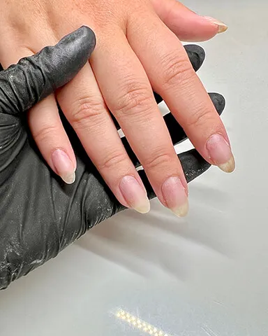 A client's hand with gel color removed