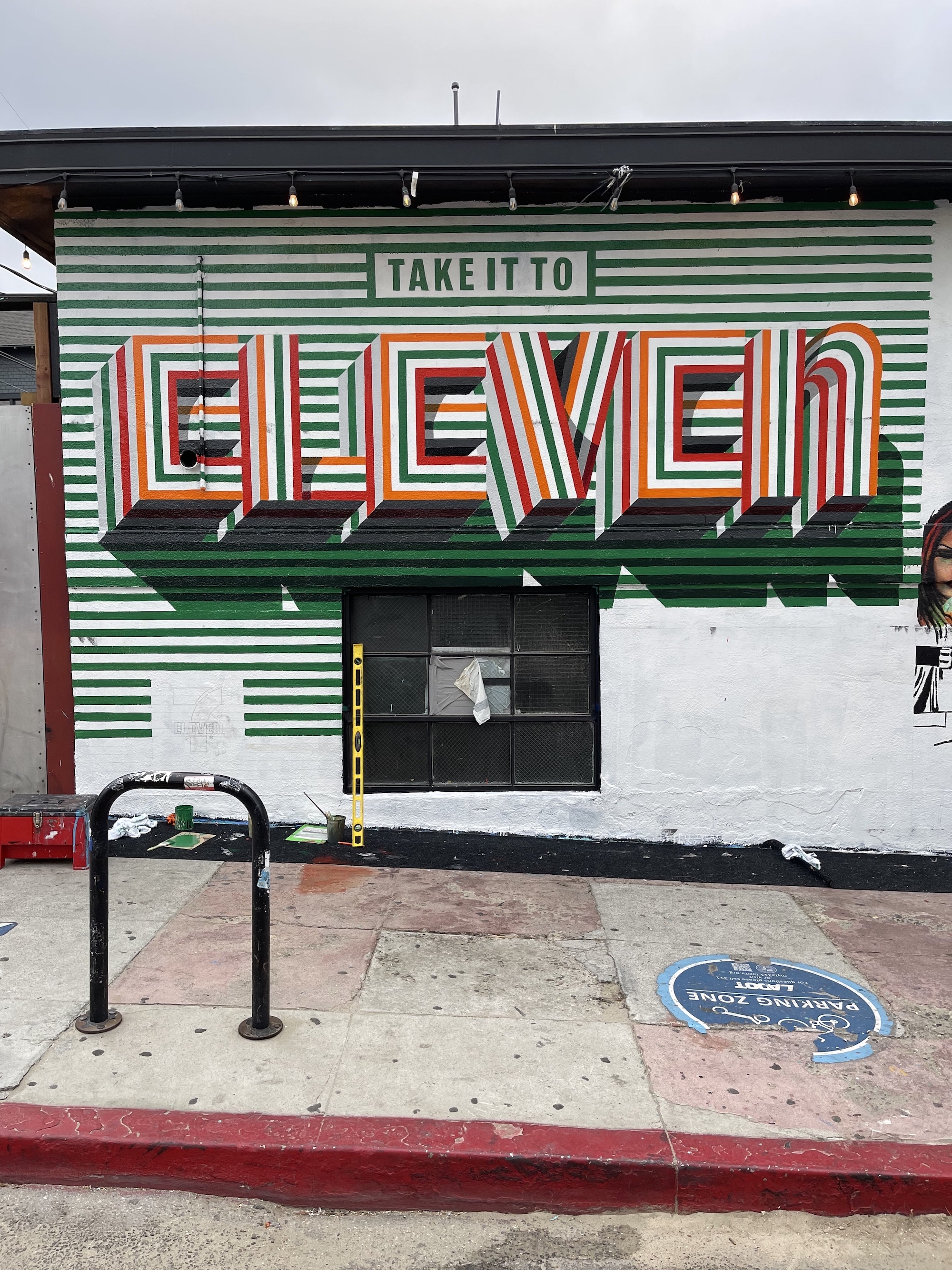 7-Eleven Take it to Eleven advertisement mural lettering in progress on Venice California building exterior