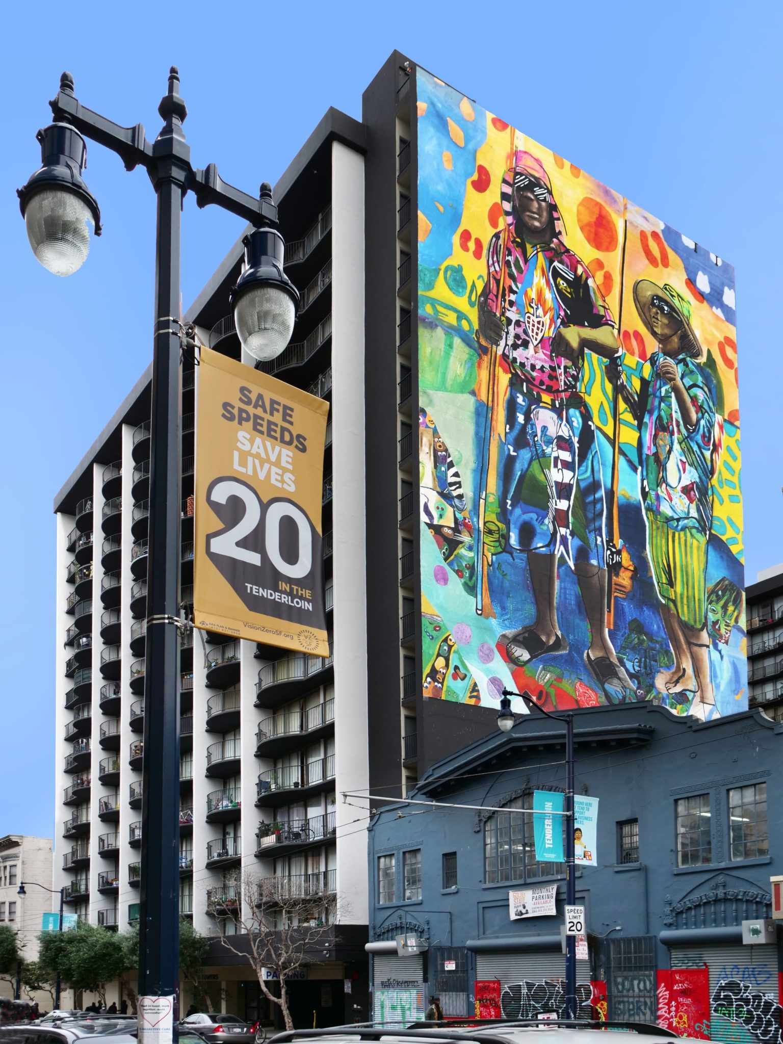 Street view of completed public art mural on multi-story building in San Francisco Tenderloin