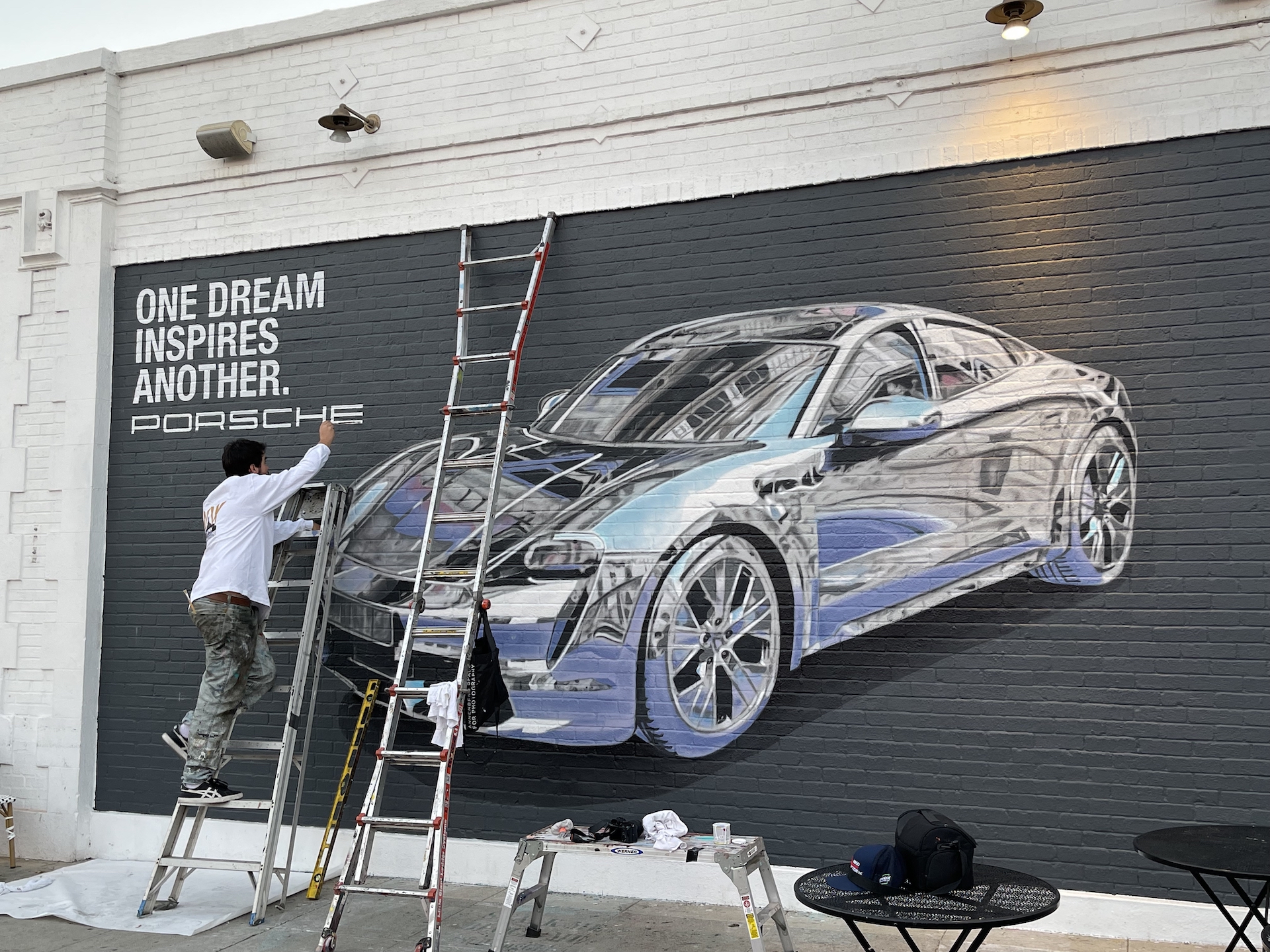 Hoist Media artist painting Porsche advertising mural in progress in West Hollywood