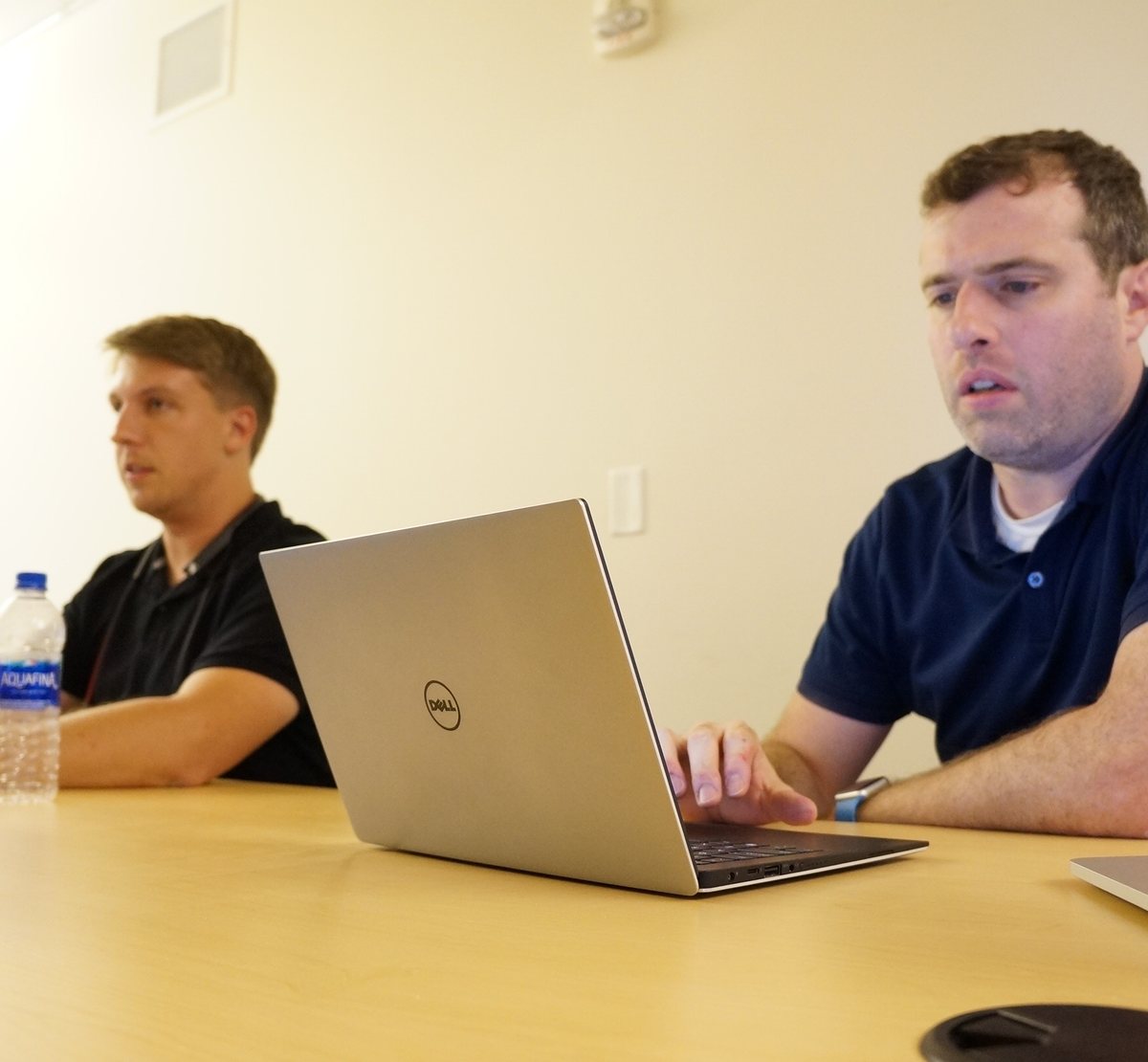 Two VAULT engineers working through a build together on one laptop