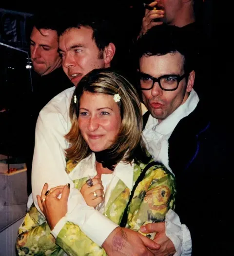 guys holding bride after wedding