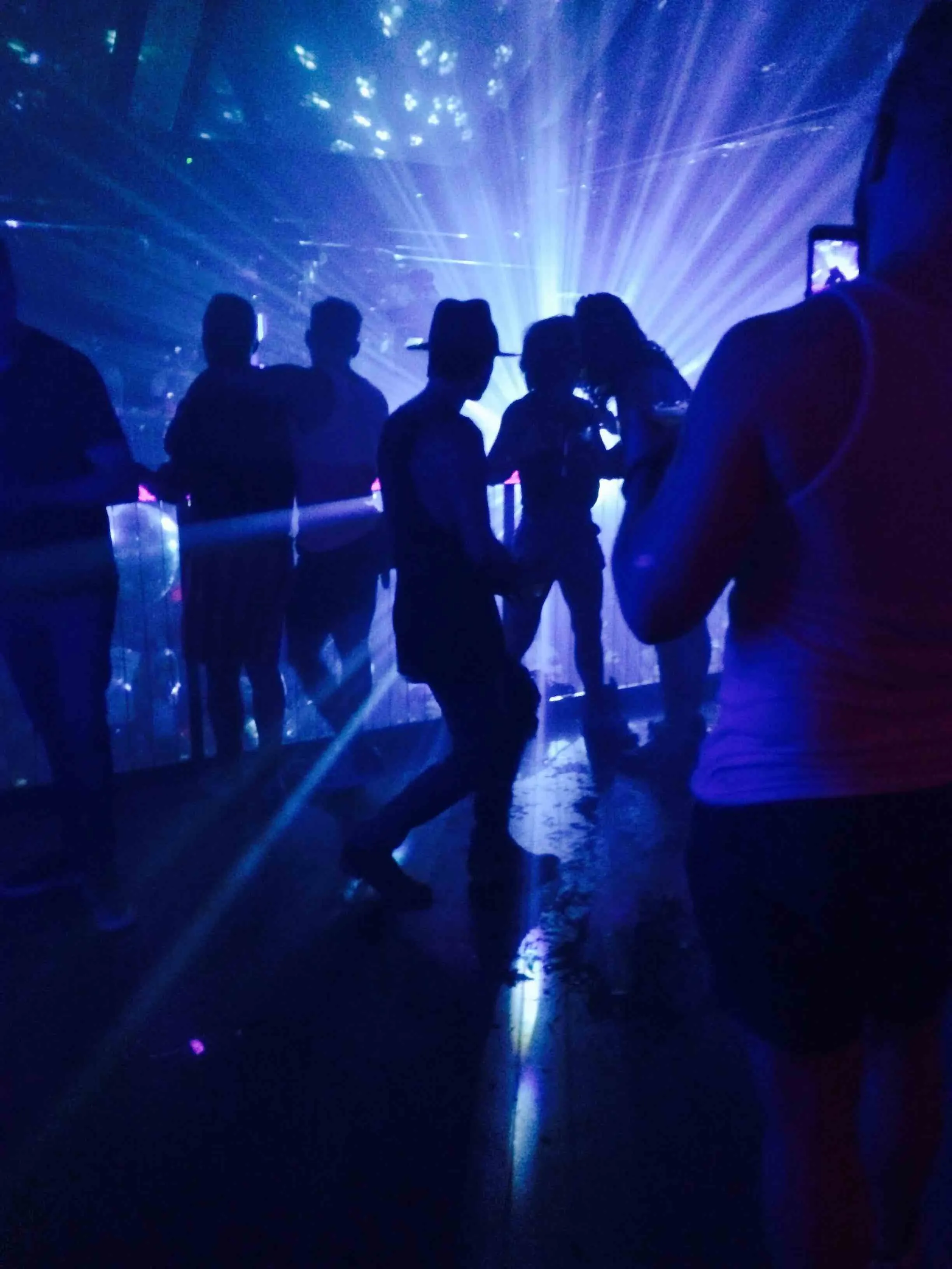 Night club lights dancing people