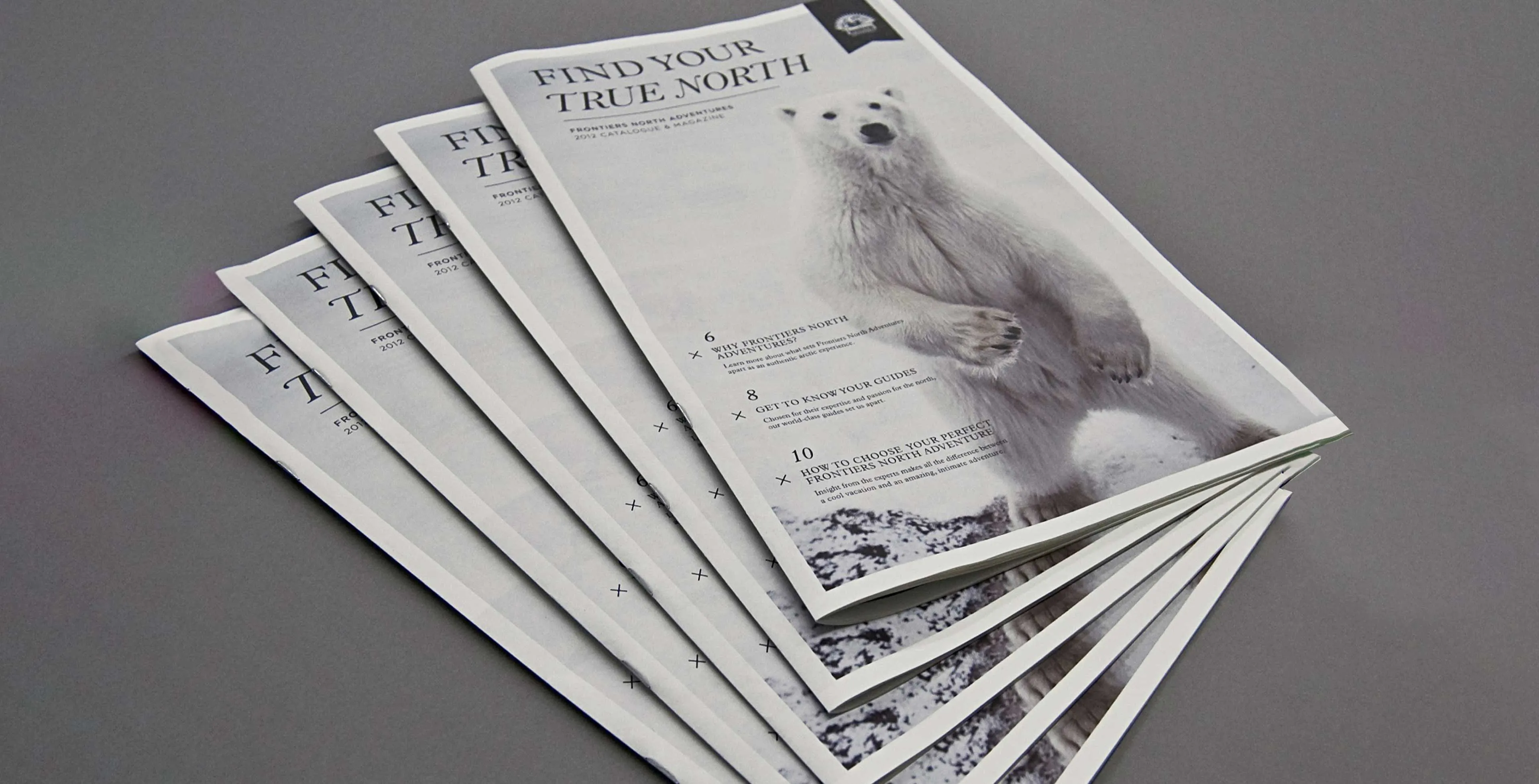 Frontiers North Adventures multiple broadsheets covers with polar bear and the logo design by Edmond Huot