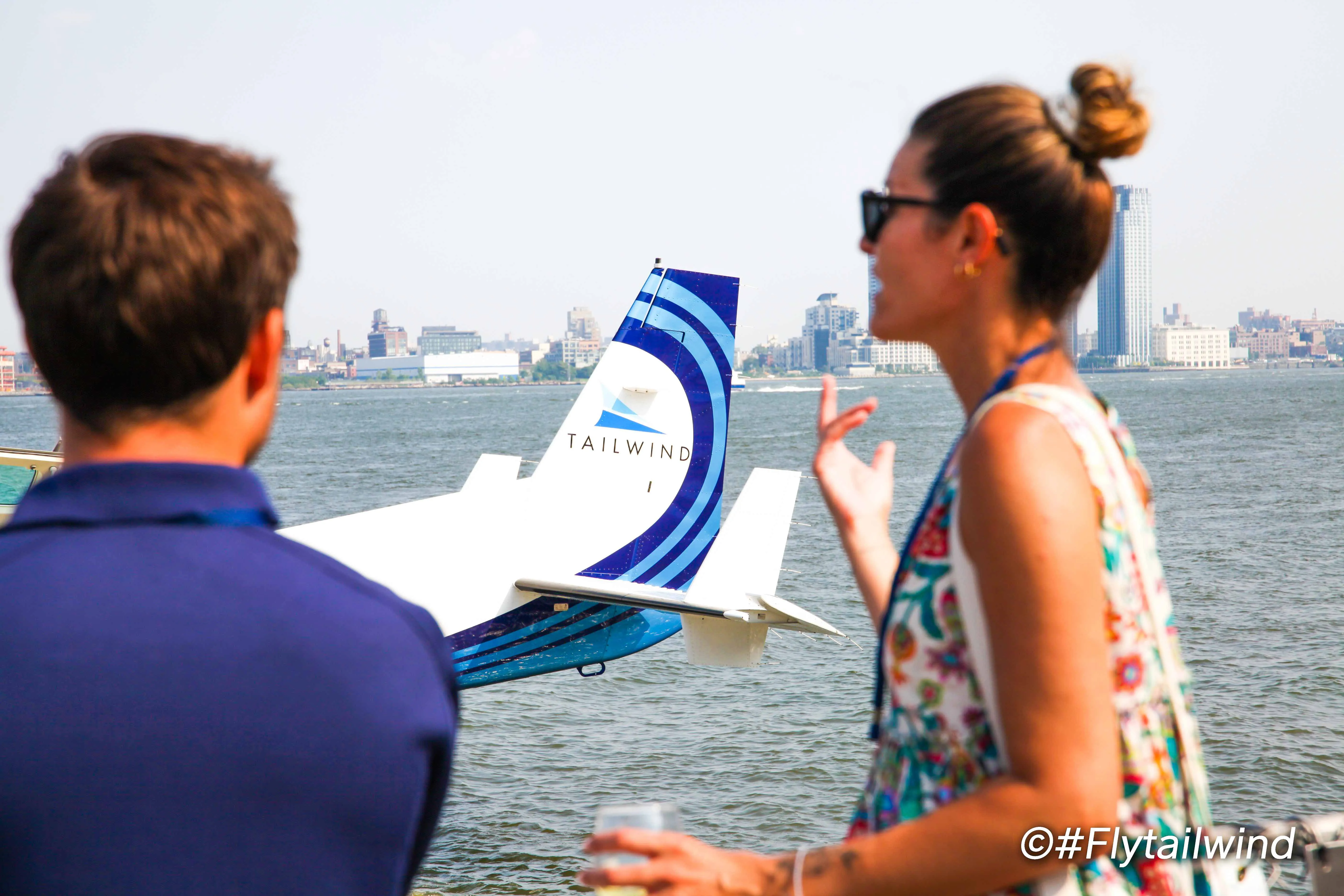 Tailwind image of aircraft travelers chatting next to Cessna 208 Amphibious Caravans