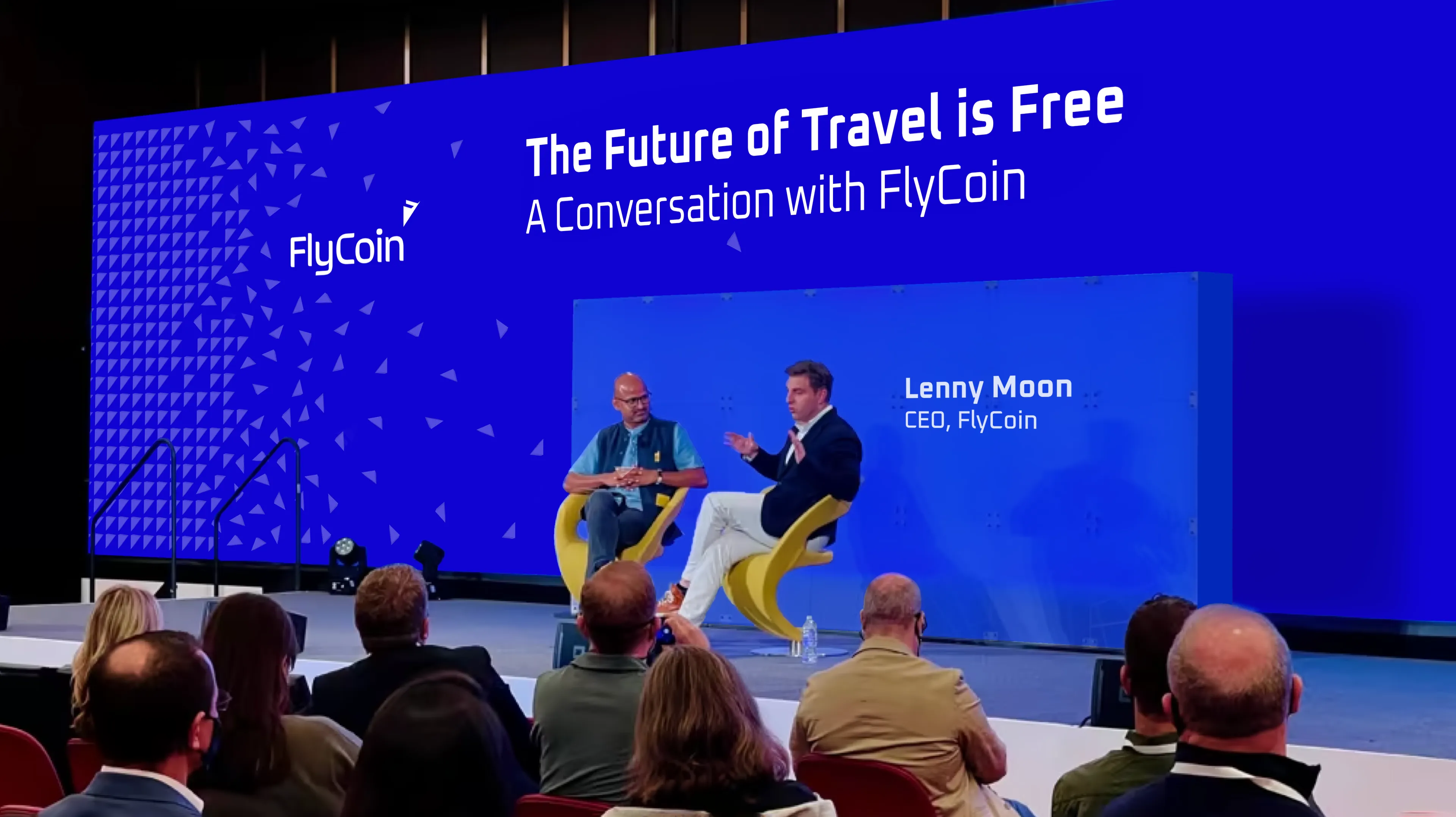 FlyCoin concept Conference MockUp with two CEO on the stage with presentation on the screens by Edmond Huot