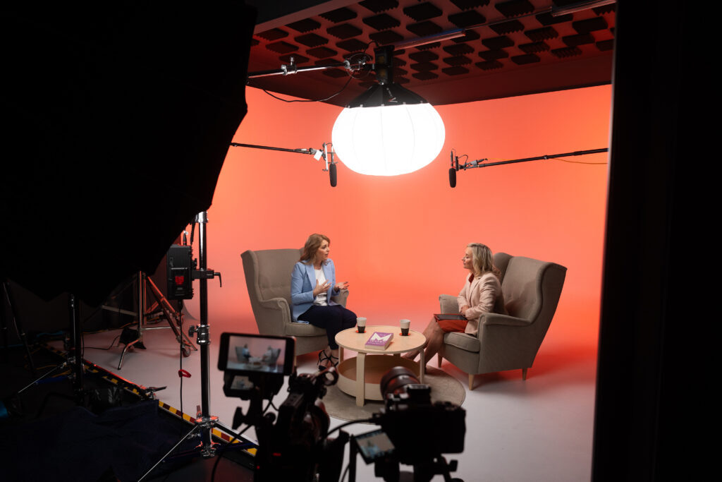 Business video production team filming a corporate interview in a modern office