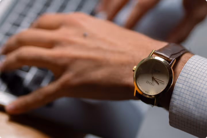 a close up of a person typing on a laptop