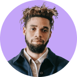 Professional headshot of a male employee with a beard wearing a dark blue overshirt.