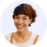 Professional headshot of a smiling female employee with short brown hair wearing a white shirt.