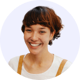 Professional headshot of a smiling female employee with short brown hair wearing a white shirt.