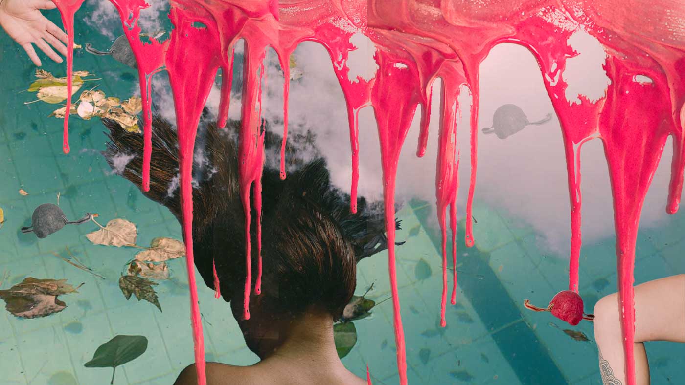 Person with wet hair submerged in water with floating leaves and red paint dripping from above.