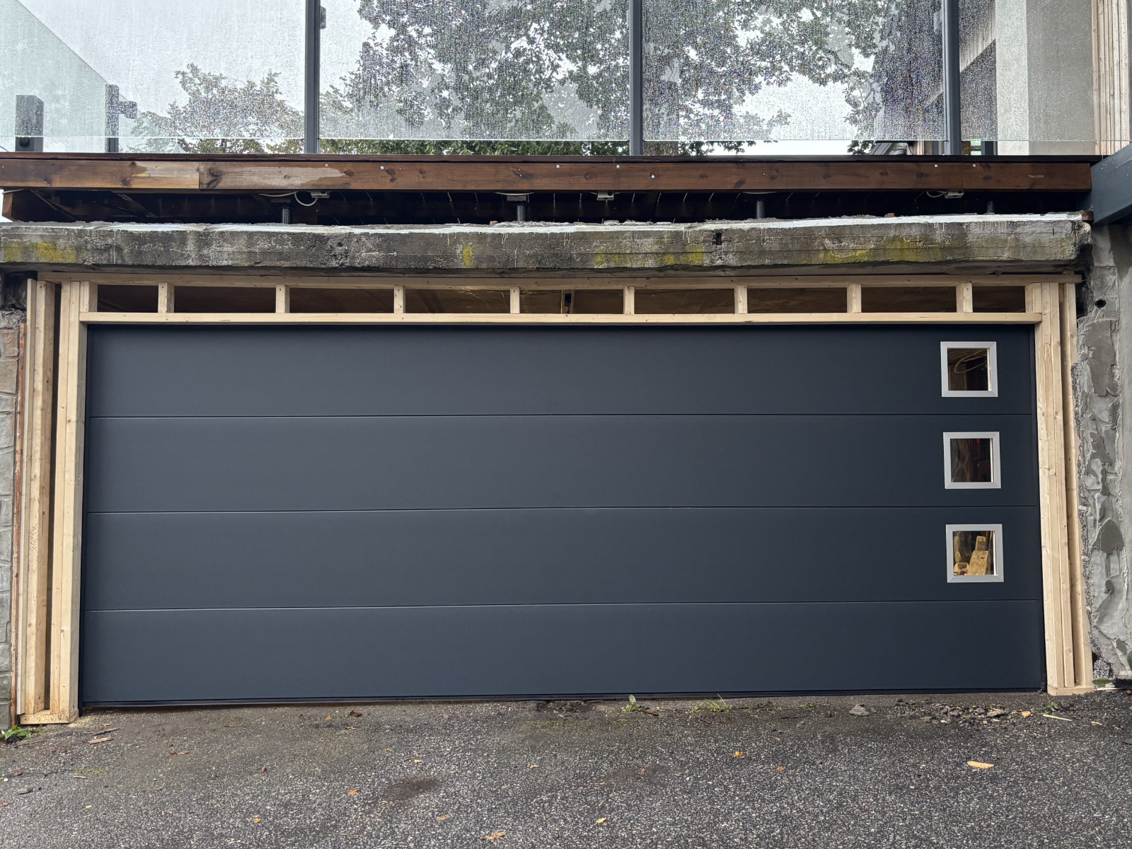 Lobas Modern, slett mørk garasjeport med kvadratiske vinduer