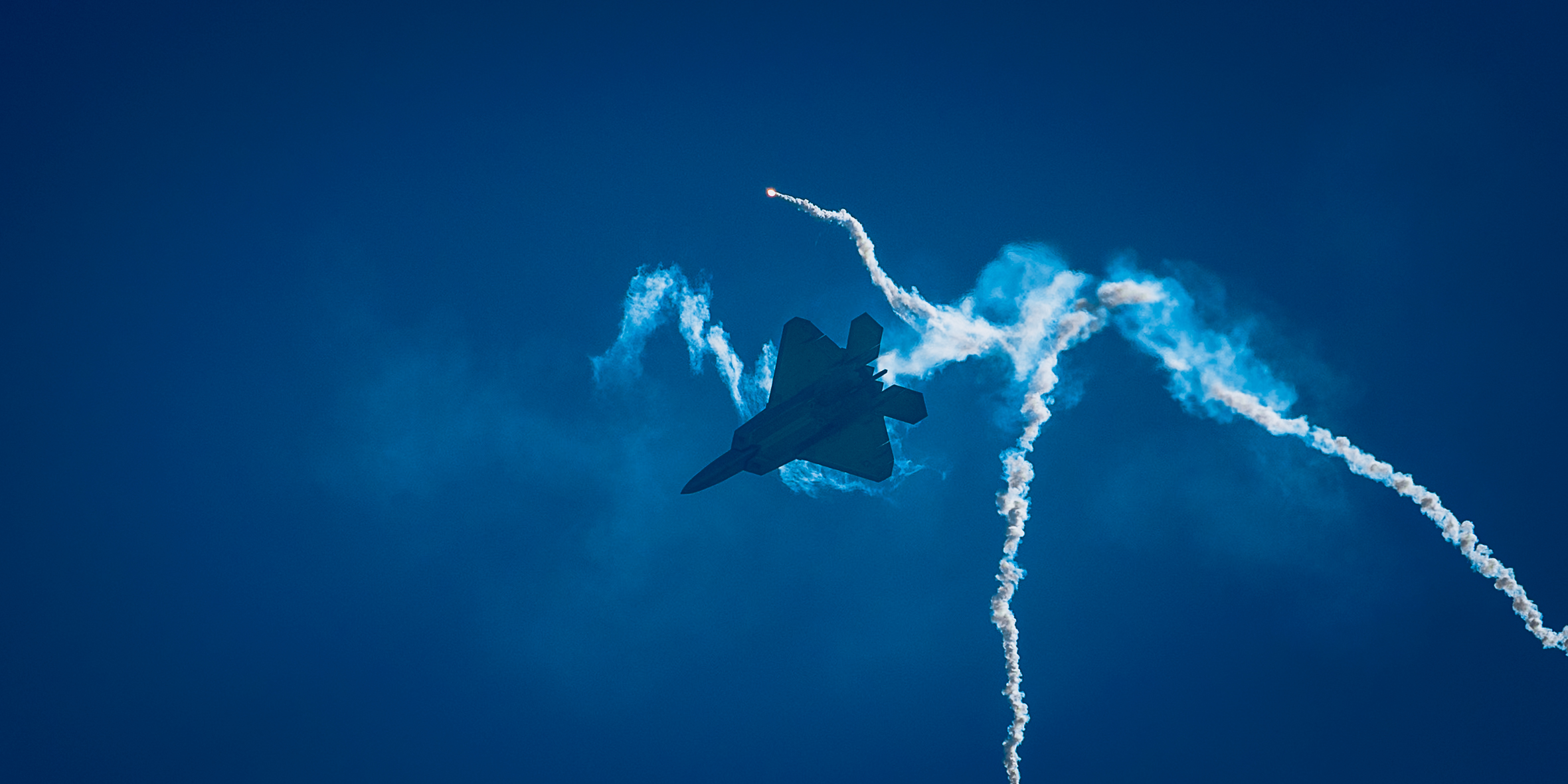 A sunset with fisherman in foreground