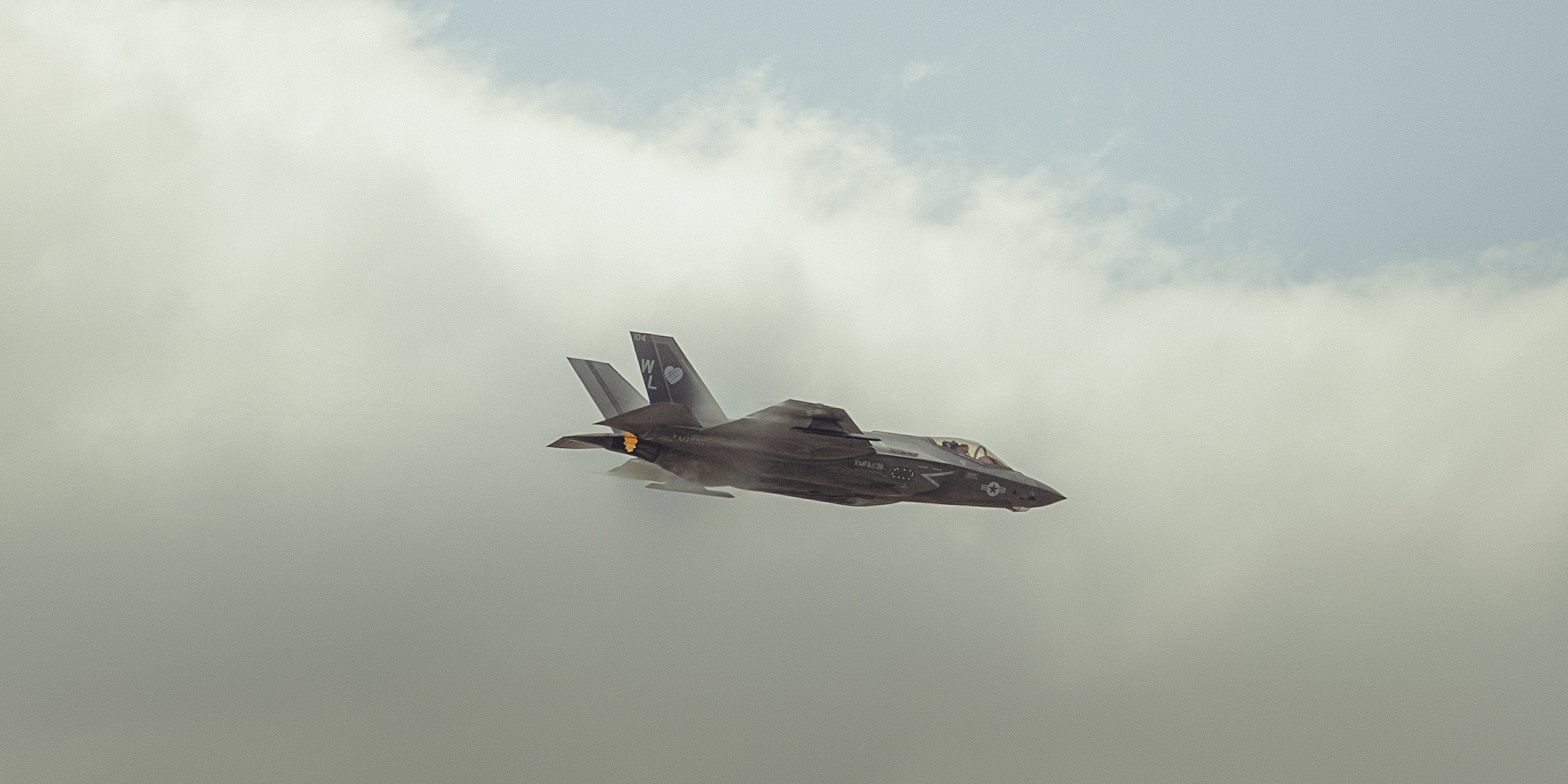 A sunset with fisherman in foreground