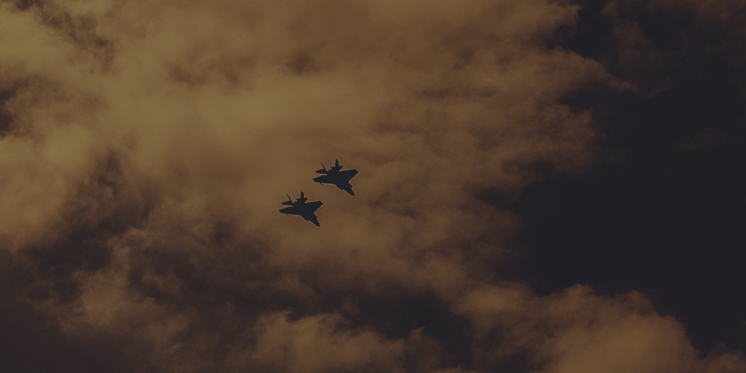 A sunset with fisherman in foreground