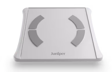 White Juniper body composition scale with four gray sensor pads and digital display on top.