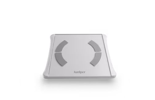 White Juniper body composition scale with four gray sensor pads and digital display on top.