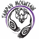 Logo with a buffalo head inside a purple circle and two black abstract hand shapes below it, text arched above.
