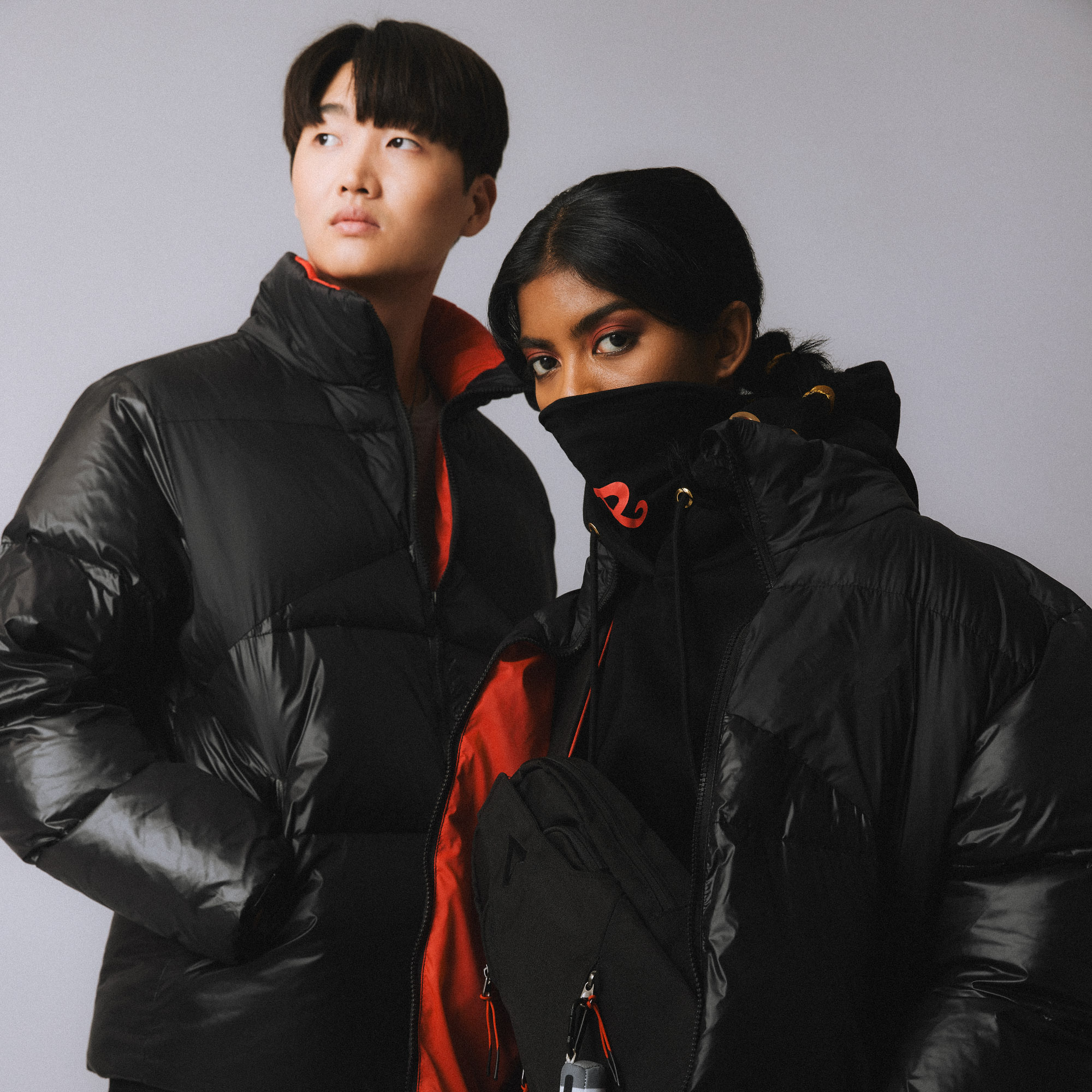 2 models wearing puffer jackets and merchandise by Apex Legends.