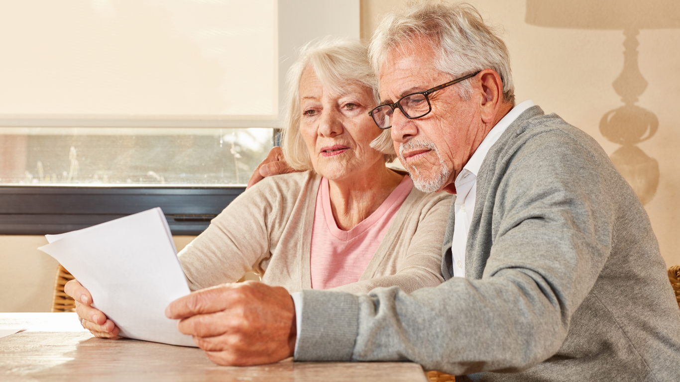 Concerned older couple reading some paperwork