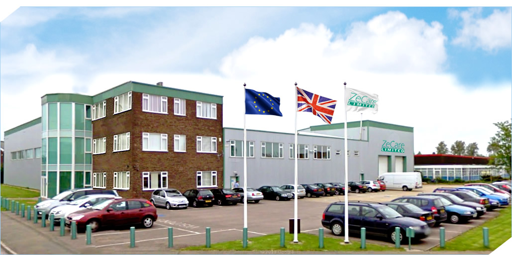 ZeCare headquarters and warehouse with company flag, EU flag, and UK flag in front, showcasing a modern office and industrial facility.
