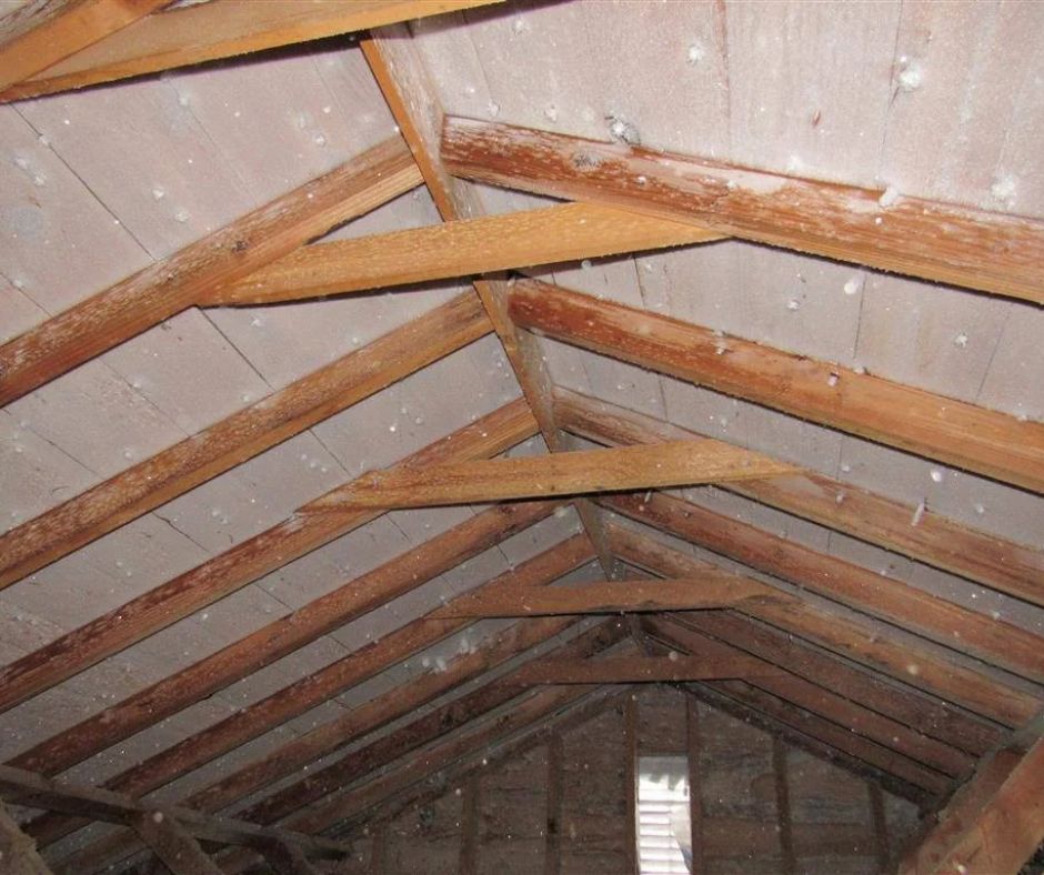 Attic of a Saskatchewan home with frost build up on the building material.