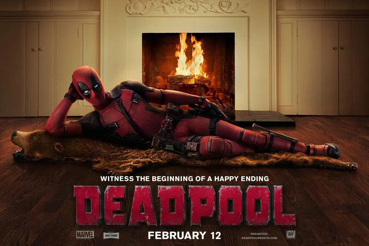 Promotional poster for the movie Deadpool showing the character Deadpool lounging on a bear rug in front of a cozy fireplace, with the tagline "WITNESS THE BEGINNING OF A HAPPY ENDING" and the release date "FEBRUARY 12" displayed.