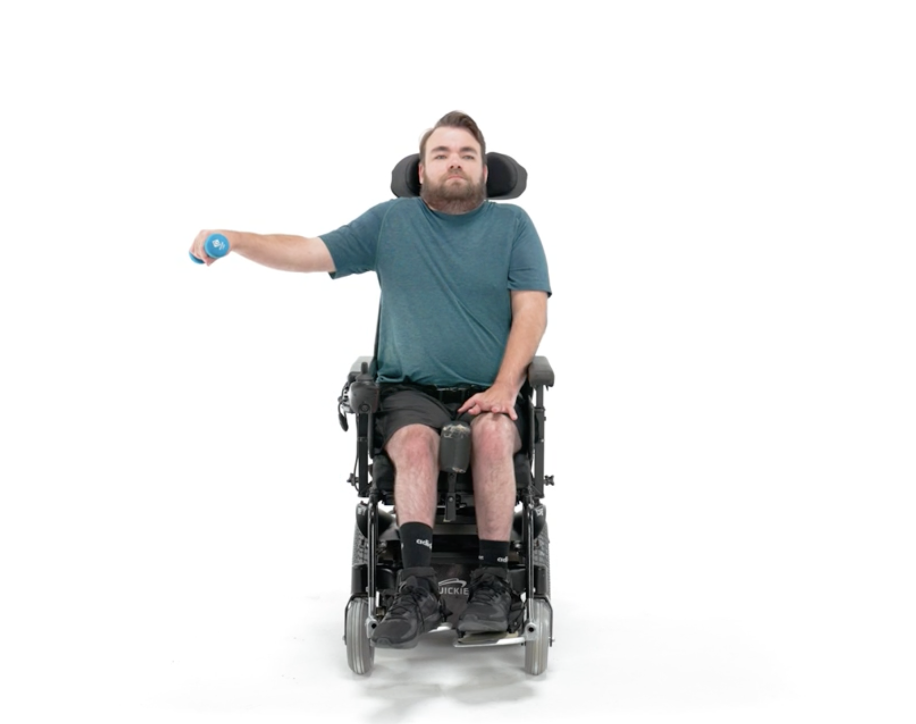 Man in a powered wheelchair extending his arm to lift a small blue dumbbell against a white background.