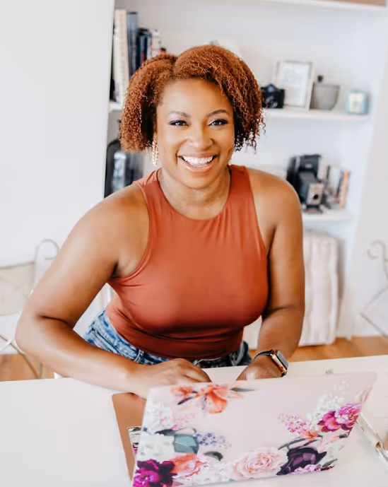 A wedding planner working on her marketing strategy at her laptop. Photo credit Bloom and Flourish Studio